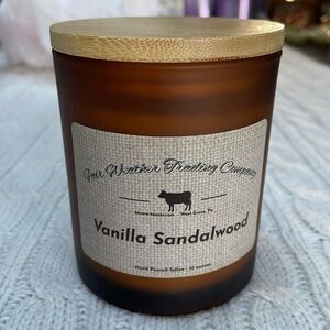 NWOT Vanilla Sandalwood candle. 10 0z. Hand poured amber glass wood lid one wick